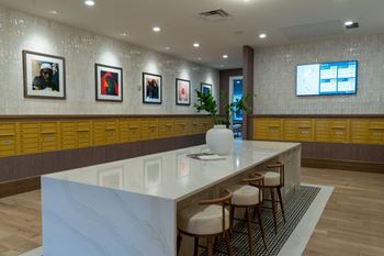 A reception area with a white counter and chairs.